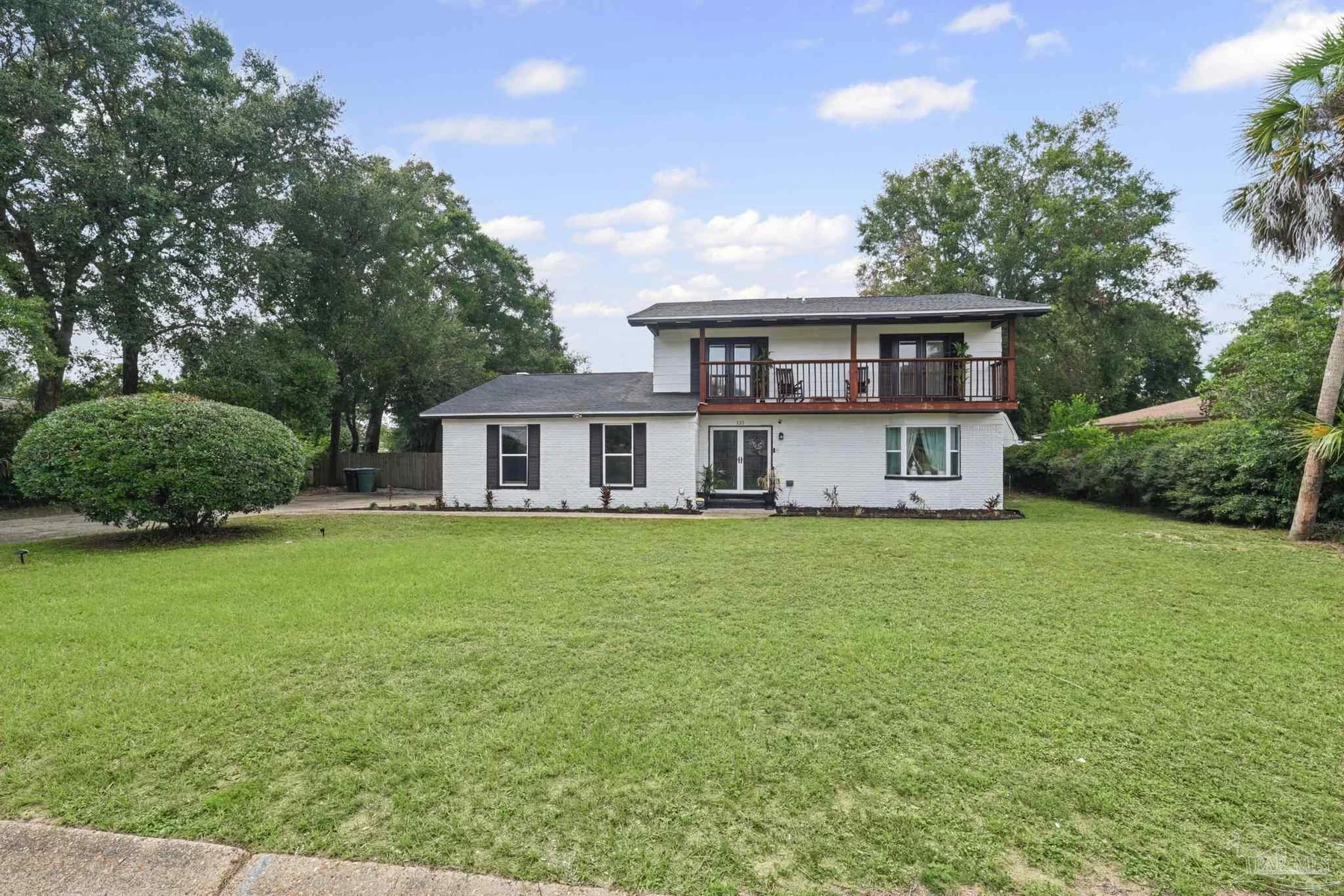 Front exterior of 121 Lovett Place across a broad green lawn